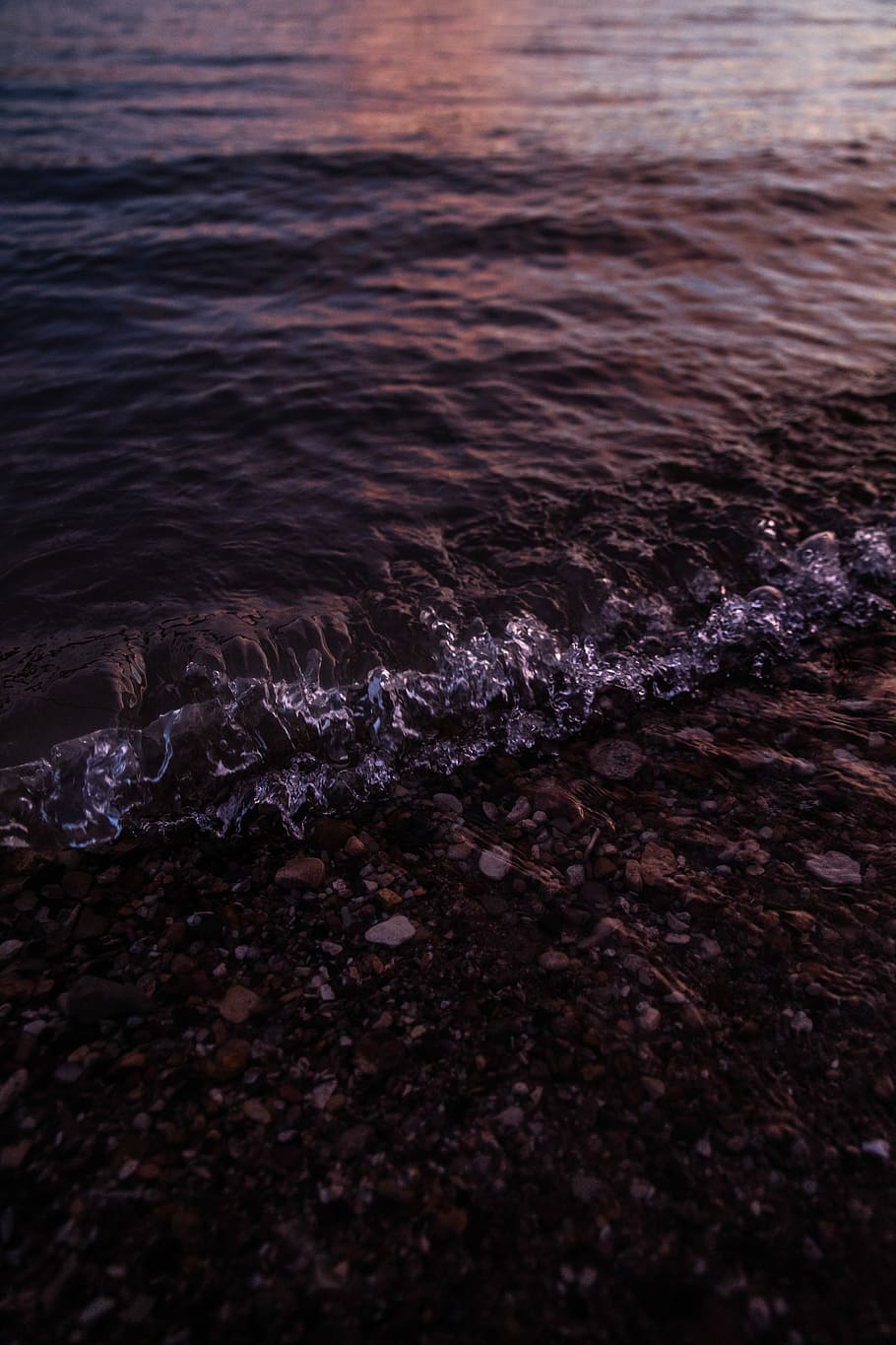 body of water during sunset, wave, stone, pebbles, beach, lake HD wallpaper