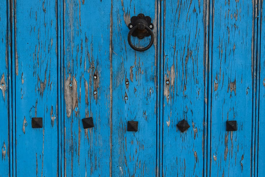 blue wooden door with black steel knocker, aged, weathered, architecture