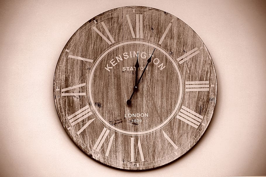 round brown analog wall clock showing 12:05, time, time clock