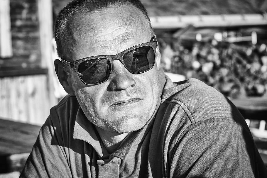 grayscale photography of man wearing sunglasses and polo shirt at daytime