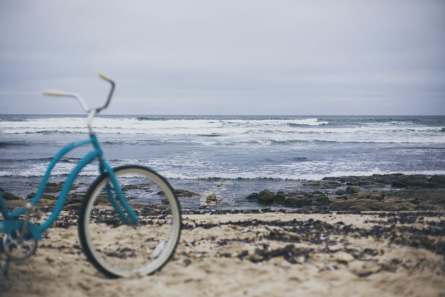 Beach rides, blue cruiser bicycle on seashore, bike, sand, water