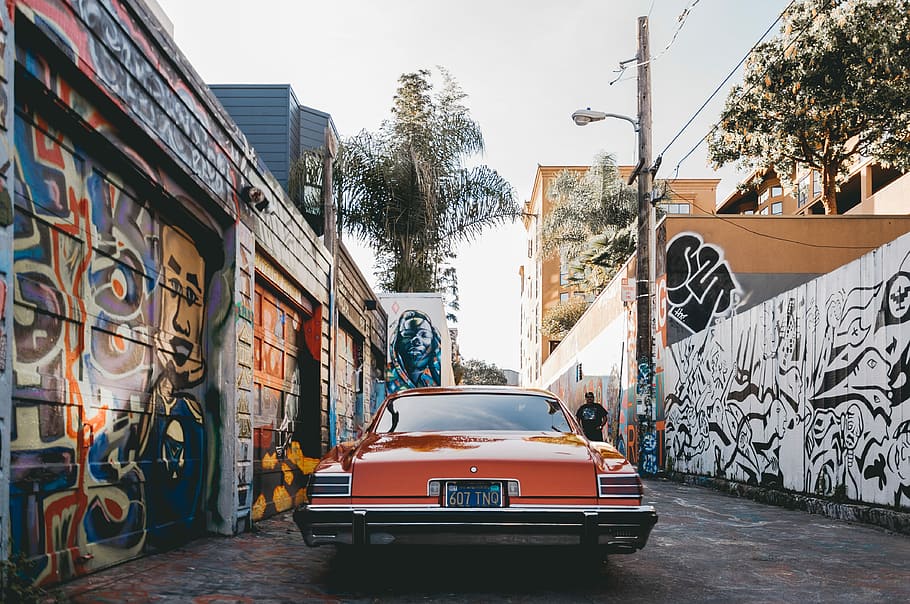 orange car parked between painted walls, vintage orange car between walls with graffiti, HD wallpaper