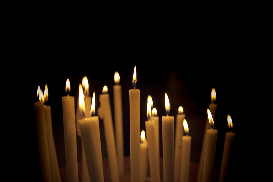 white candle lot, lighted white candles, lights, black room, flame