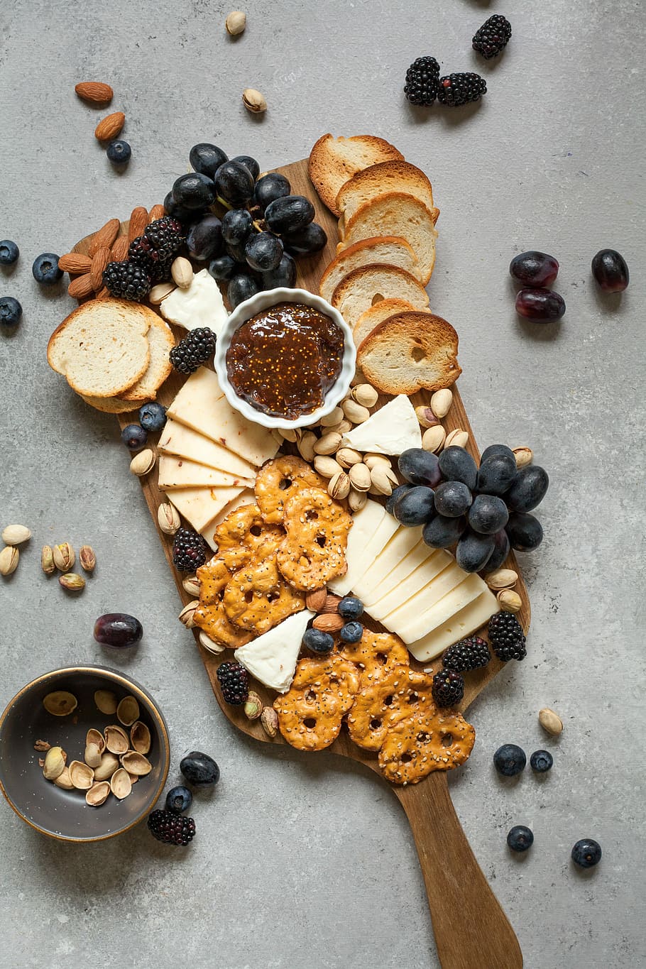 baked breads and cookies on brown wooden board, brown breads and grapes on top of brown wooden chopping board HD wallpaper