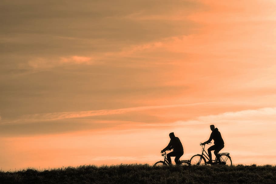 Hd Wallpaper Two Silhouette Of Man Riding Bicycle During Golden Hour Time Wallpaper Flare