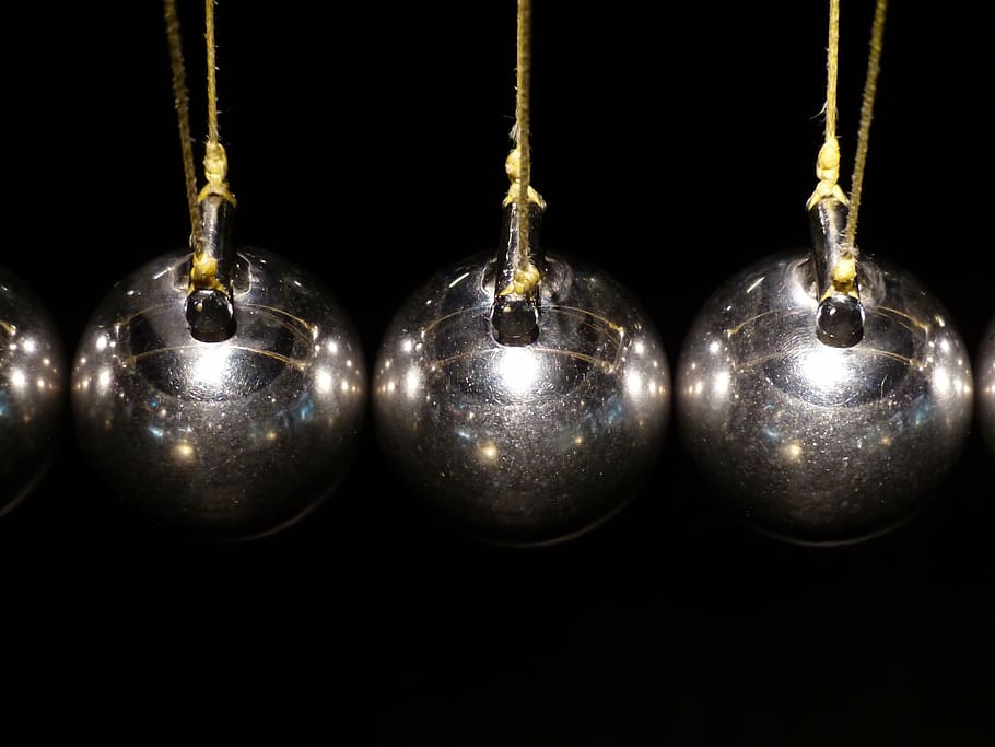 closeup photo of three gray baubles, spherical ball joint, pendulum