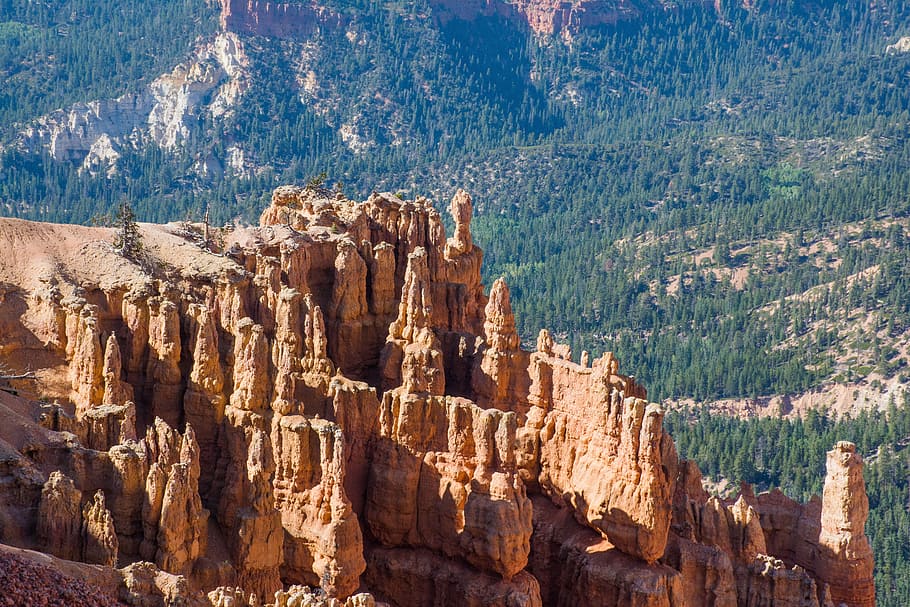 Cedar Breaks National Monument, brown rock formations with view of tree-covered mountain aerial photo HD wallpaper