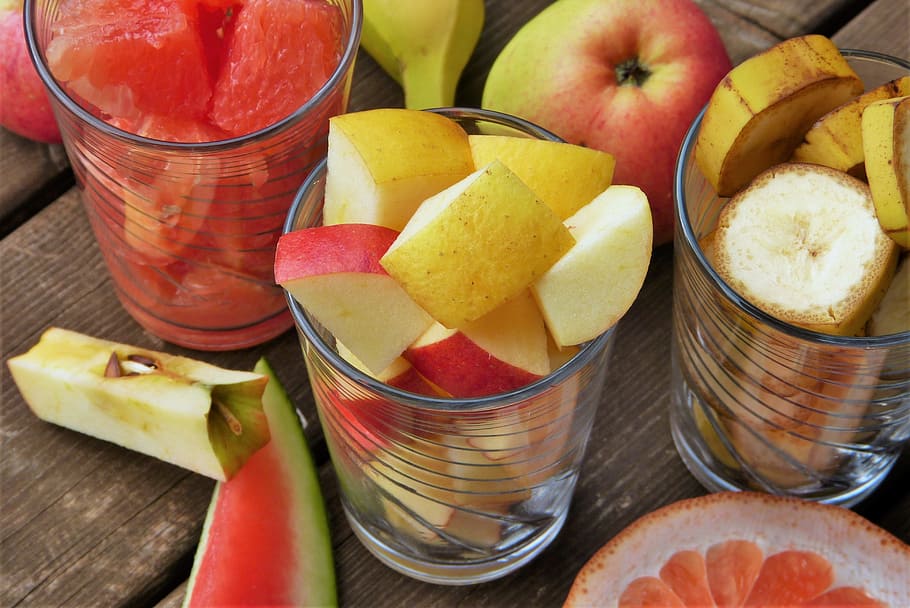 assorted fruits on glass cup, fruit salad, apple, cut, grapefruit