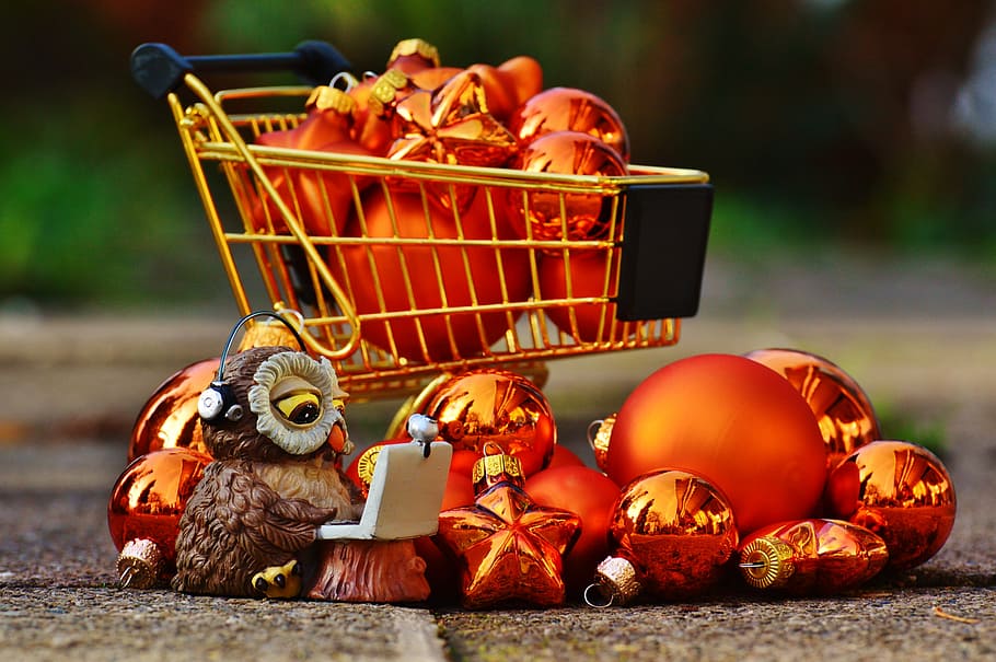 gold bauble lot in gold shopping cart selective focus photography