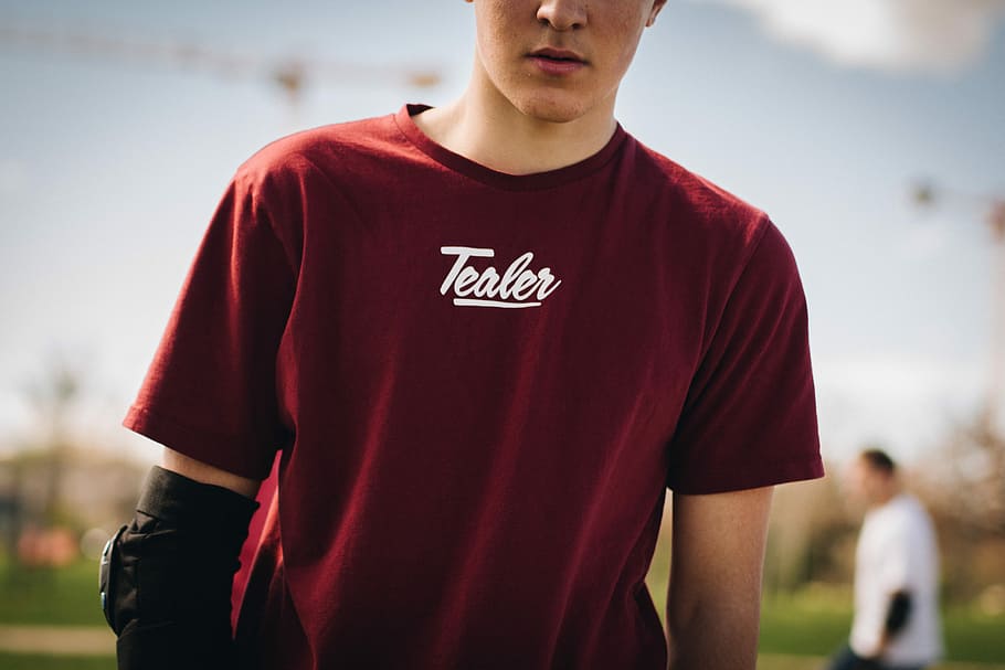 man in red crew-neck shirt under sunny sky, closeup photo of man wearing red tealer-printed t-shirt