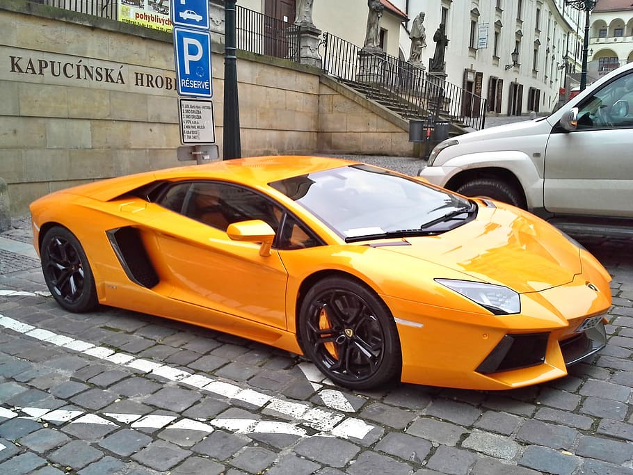 orange Lamborghini Aventador coupe on parking lot, brno, racing car