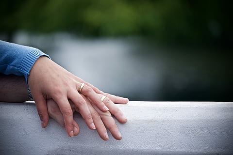 two hands on gray surface, two human hands with gold-colored rings selective focus photography HD wallpaper