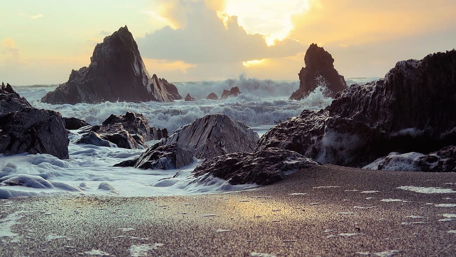 sea waves raging near coast during golden hour, rocks, sand HD wallpaper
