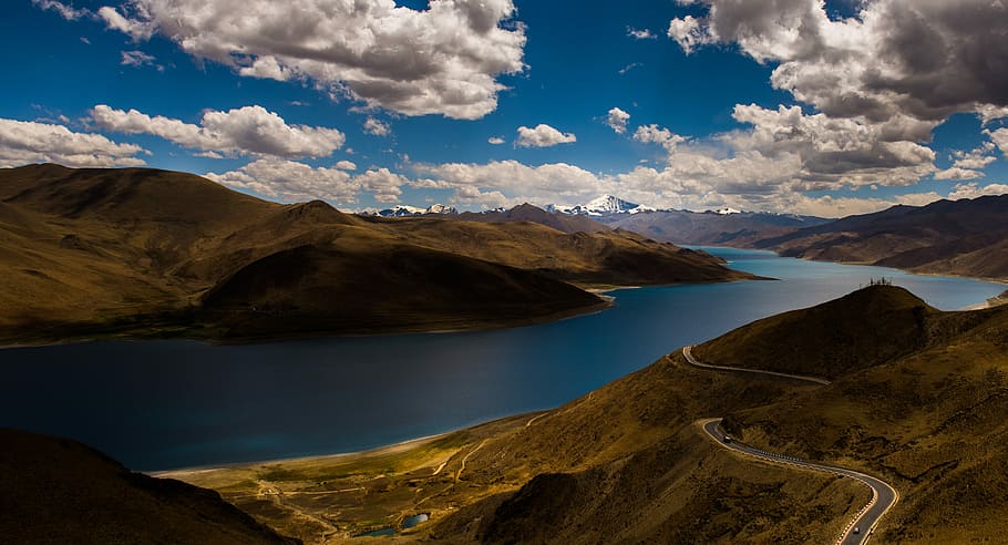 aerial photo of road in a distance of lake and mountain, high-angle photography of body of water between mountain HD wallpaper