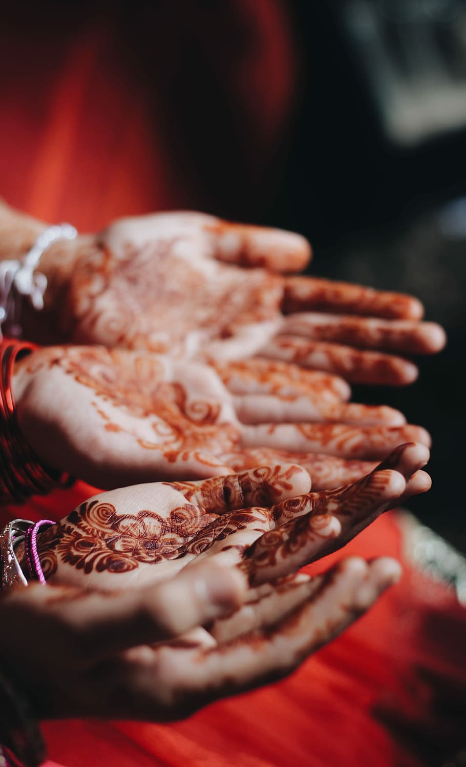 women with mendhi tattoos, bridal mehndi in shallow focus photography