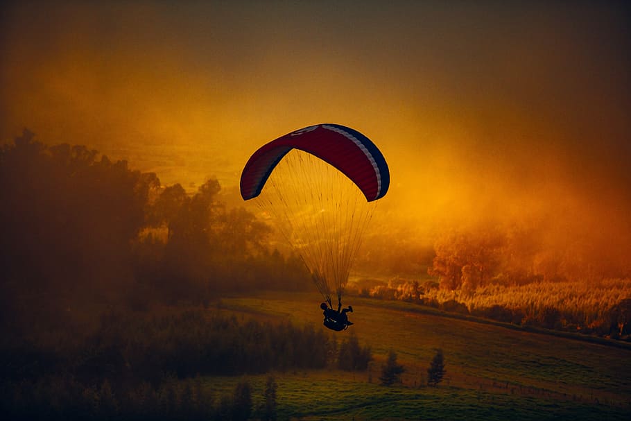 man riding parachute during golden hour, adventure, clouds HD wallpaper