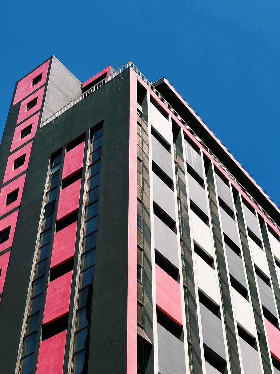 black and pink concrete building, pink and gray concrete building under blue sky HD wallpaper
