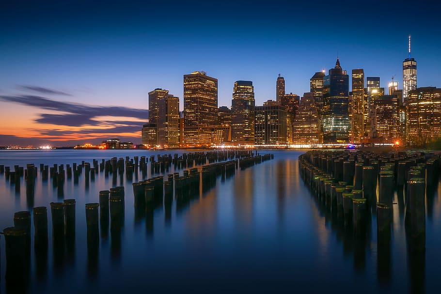 concrete post on body of water near buildings, city, photo HD wallpaper