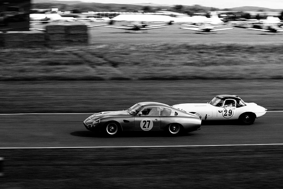 two vintage race cars racing, gray car on road, speed, fast, track