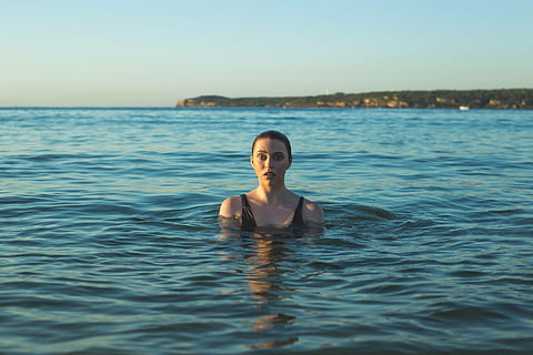 woman wearing black tank top swimming on sea at daytime, beach HD wallpaper