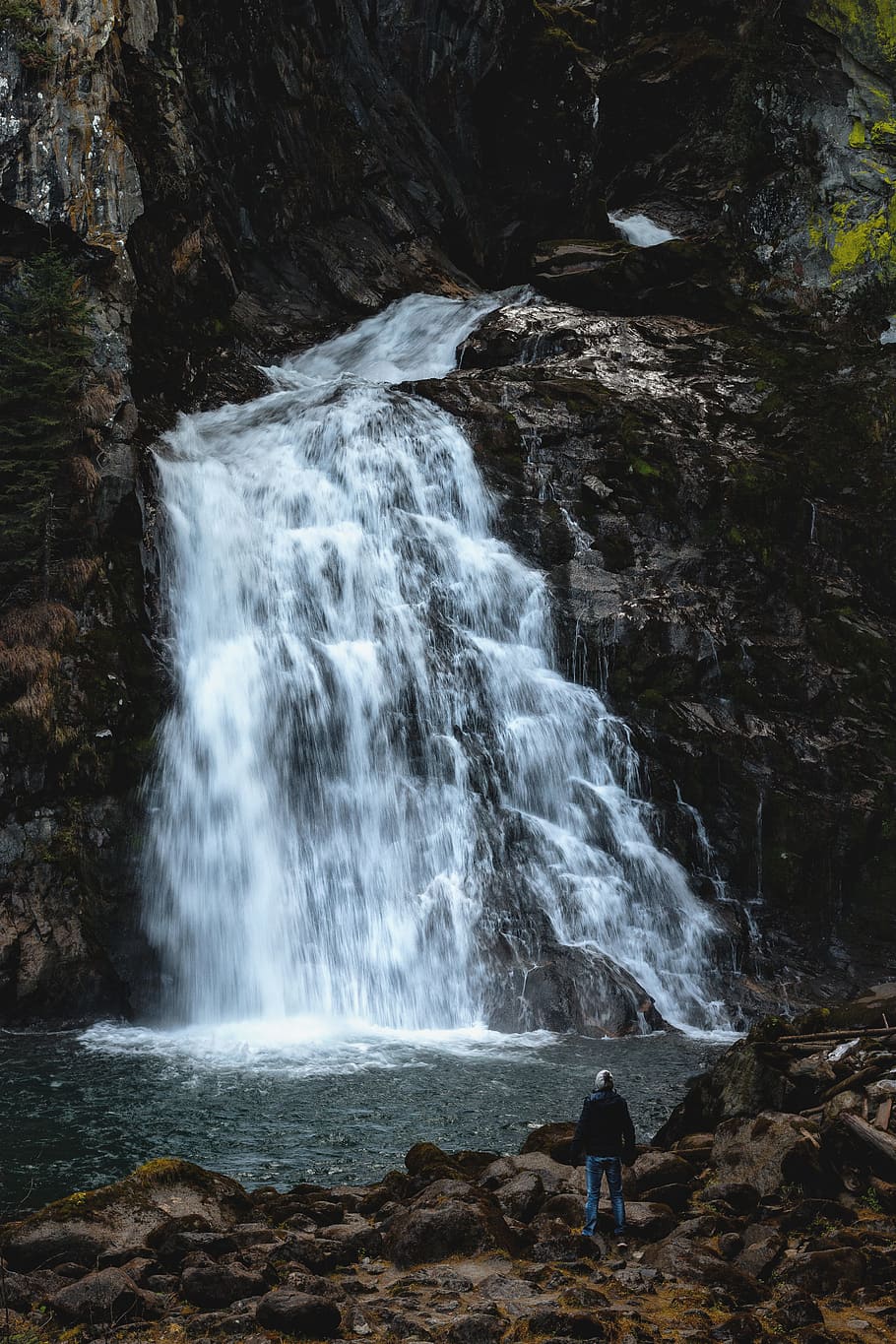 Man Standing Near Waterfalls, cascade, daylight, environment HD wallpaper