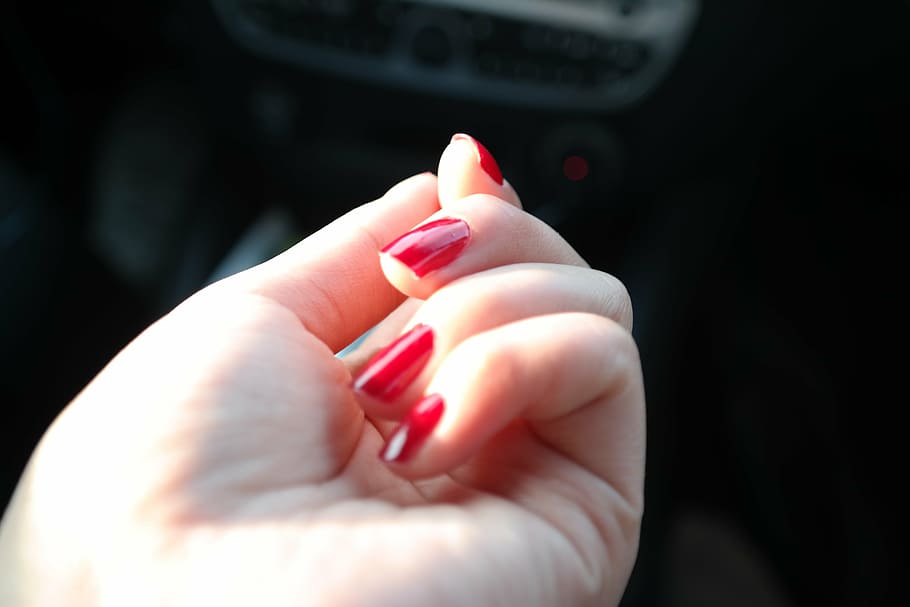 woman's hand with red manicure, nail polish, nail varnish, fingernails