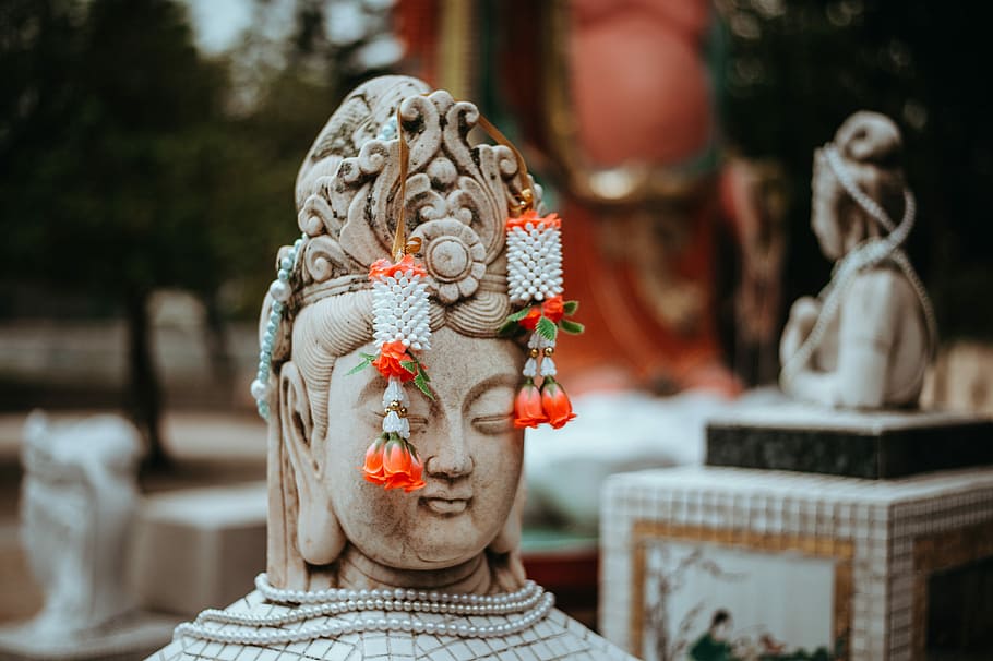 Colours of Hong Kong, pair of white-and-red drop earrings on Buddha statue HD wallpaper