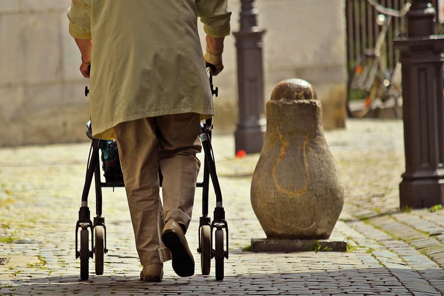 man walking with stroller, human, seniors, old woman, lame, seniorin