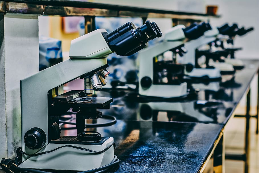 white microscope on top of black table, selective focus photography of white and black microscope HD wallpaper