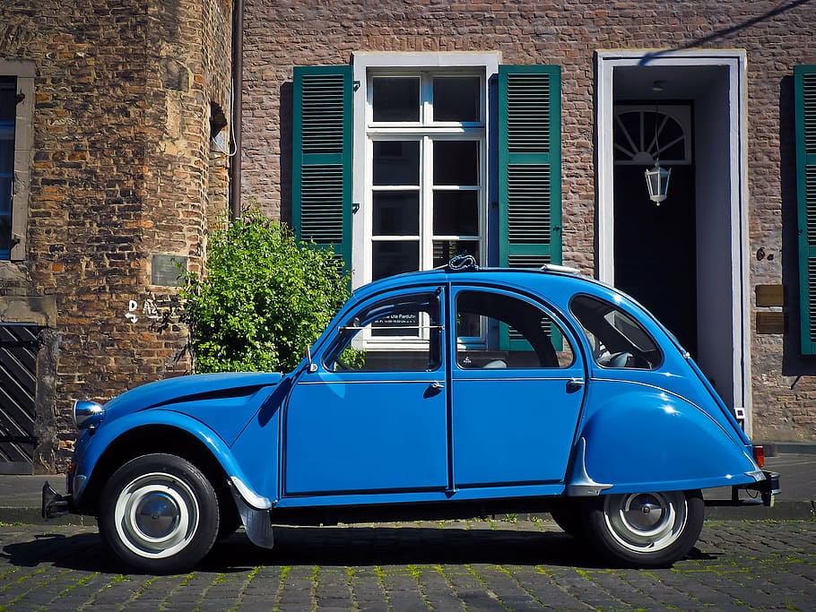 blue Citroen 2CV near brown wall bricks during daytime, auto HD wallpaper