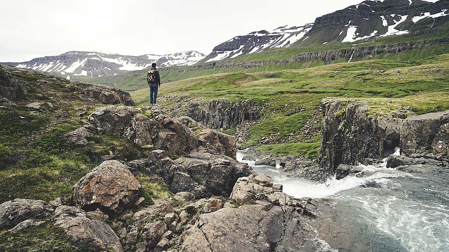 man standing on rock near of waterfalls, person, wearing, backpack HD wallpaper