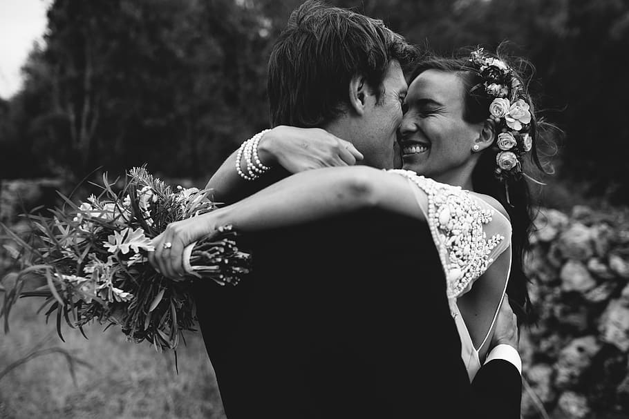 Wedding Ceremony, man and woman hugging near flowers, couple