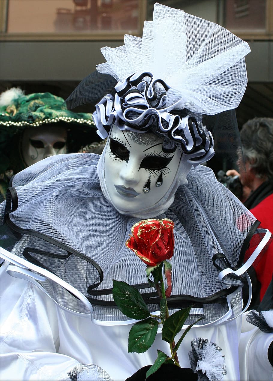 person wearing white and black face mask, clothing, cover, carnival