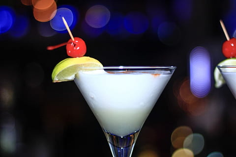 martini glass filled with white liquid in selective focus photo HD wallpaper