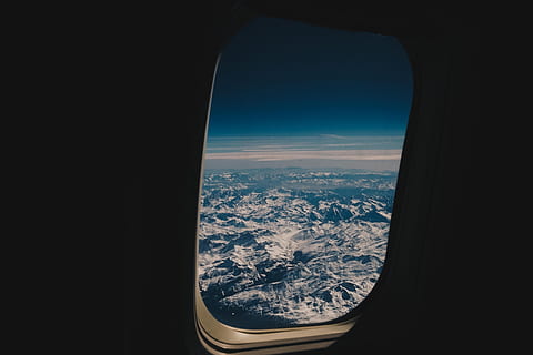 Flying high, aerial view of snow-capped mountain, window, airplane window HD wallpaper