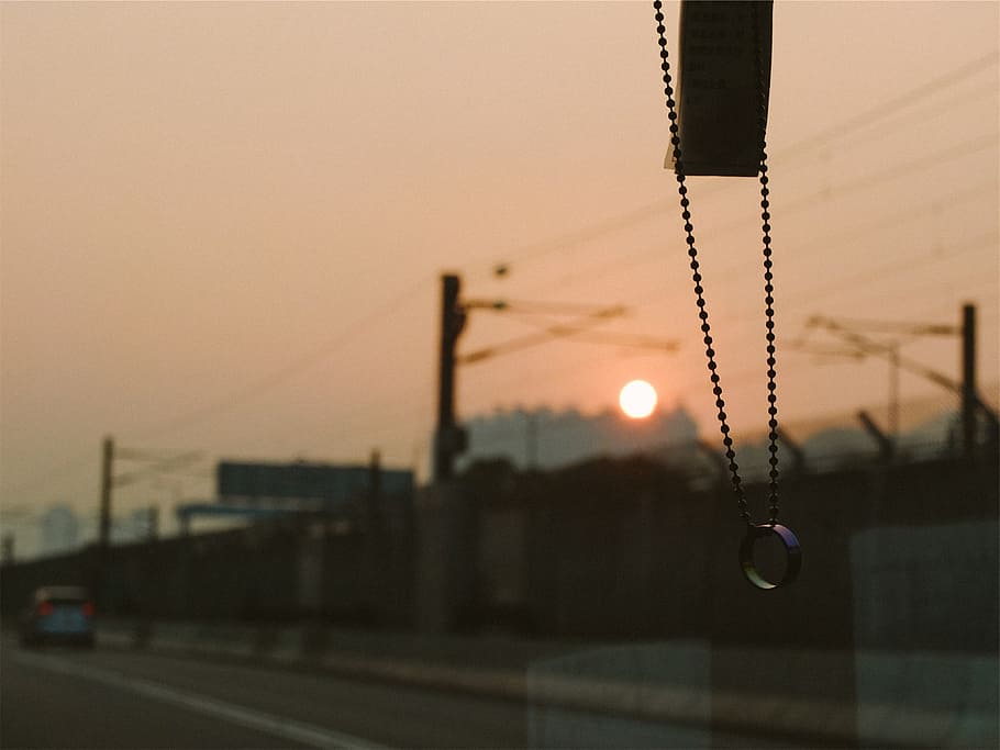 beads, ring, windshield, driving, road, sunset, sky, focus on foreground HD wallpaper