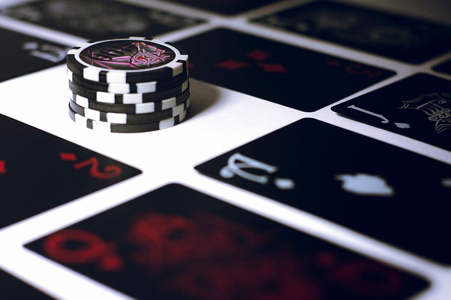 poker chip on white surface, black-and-white poker chips on surface