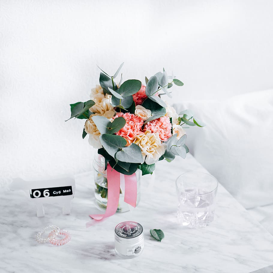 pink and beige flowers, pink and yellow flowers in clear glass vase centerpiece on white table HD wallpaper