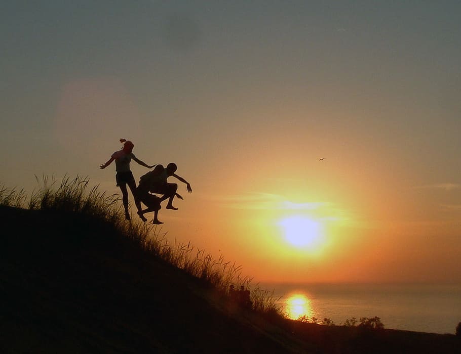 Jumping down the hill at sunset, children, photo, fun, kids, landscape