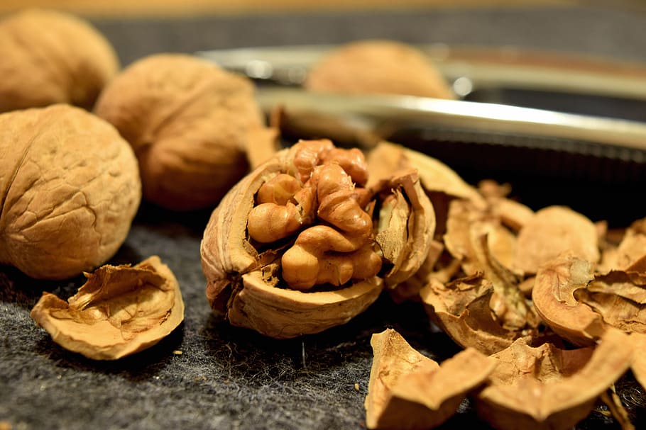 cracked walnut on black surface, walnuts, snack, protein, brown HD wallpaper