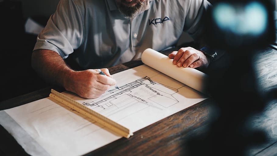 An architect working on a draft with a pencil and ruler, man sketching on pad using pen and ruler, HD wallpaper