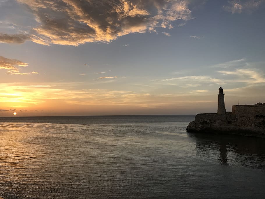 gray concrete lighthouse near body of water during daytime HD wallpaper