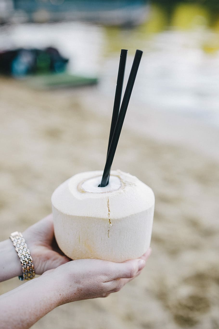 Female holding a fresh coconut, summer, fruit, holidays, vacations HD wallpaper