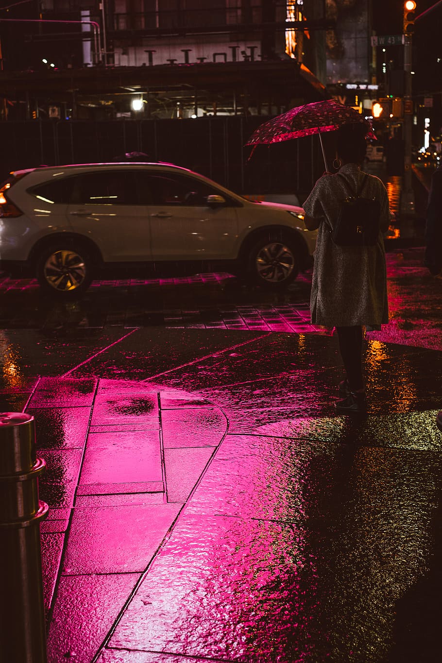 person holding umbrella while walking, woman holding open polka-dot umbrella facing backwards