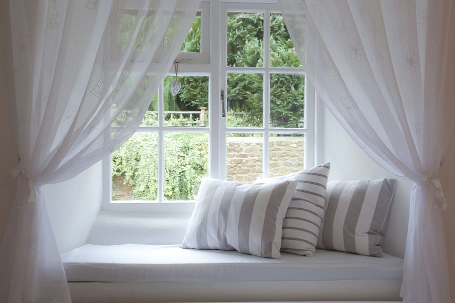 three gray-and-white striped throw pillows beside clear glass window HD wallpaper