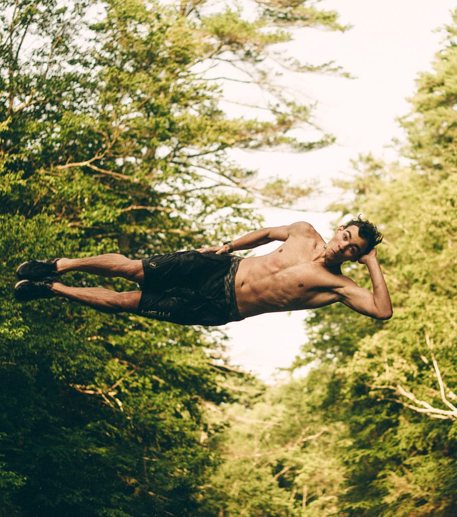 man on mid air near trees at daytime, man hands on head jumping on water HD wallpaper