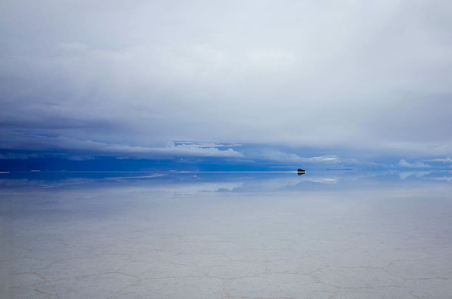 Uyuni Salt Flat, black boat on body of water under cloudy skies HD wallpaper