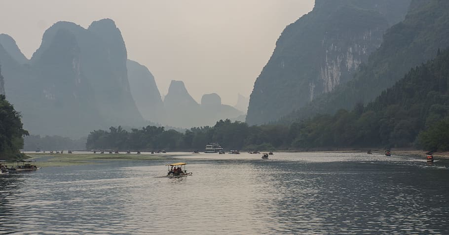 boats on body of water near mountains at daytime, china, giulin