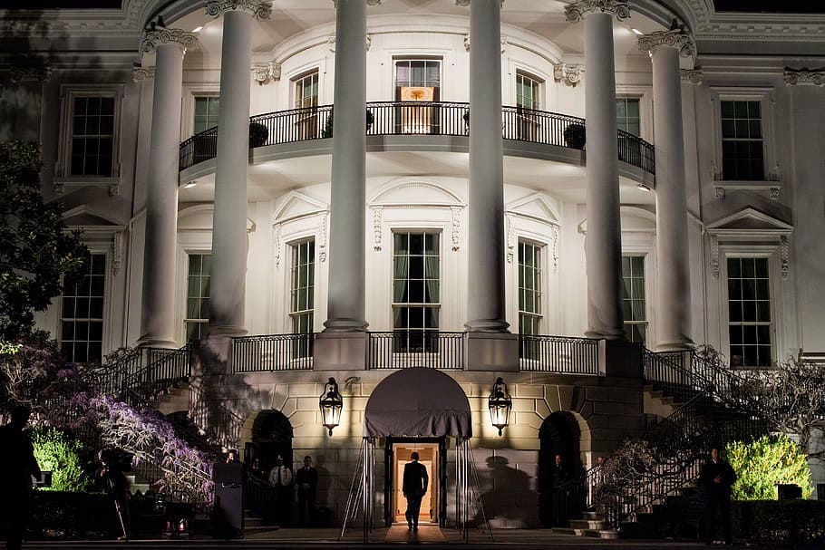 person walking inside white painted building, the white house
