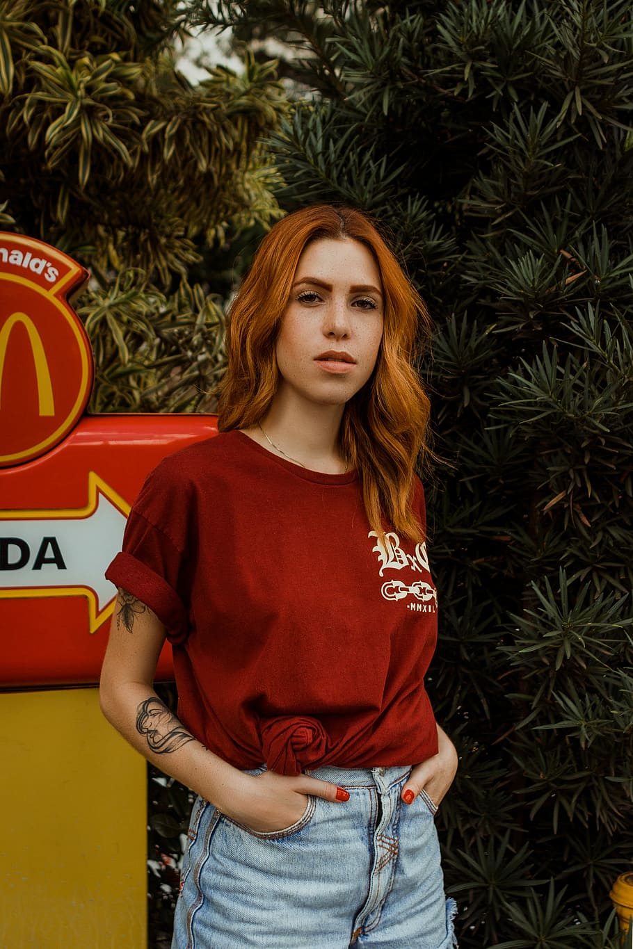 woman put her hand in her pocket in front of Mcdonald signage, woman tucking his hand on pocket near tree, HD wallpaper